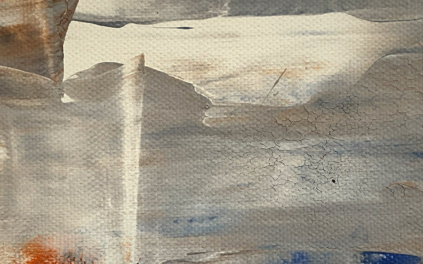 Close-up of cracked paint texture on canvas in muted gray, blue and rust tones