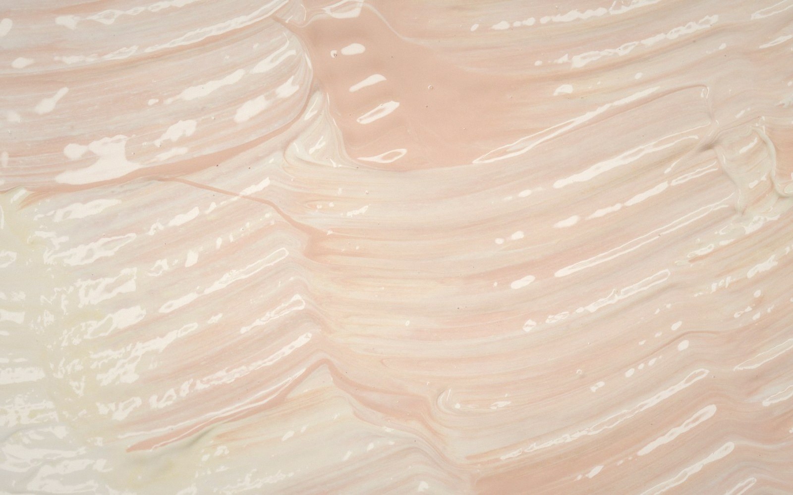 Swirling pink and white cream forms wavy ridged lines across the surface